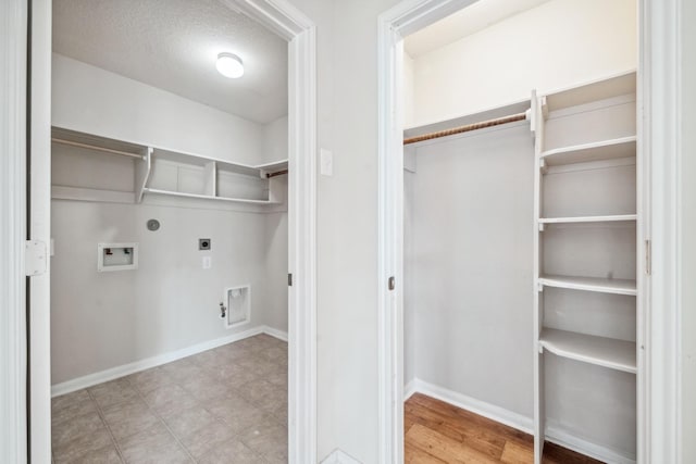 clothes washing area featuring a textured ceiling, hookup for a gas dryer, hookup for a washing machine, and electric dryer hookup