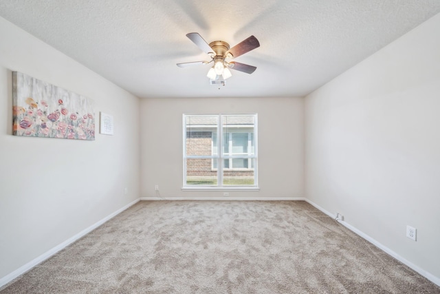 carpeted empty room with ceiling fan and a textured ceiling