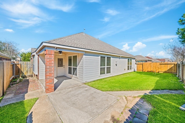 back of house with a lawn, ceiling fan, and a patio area