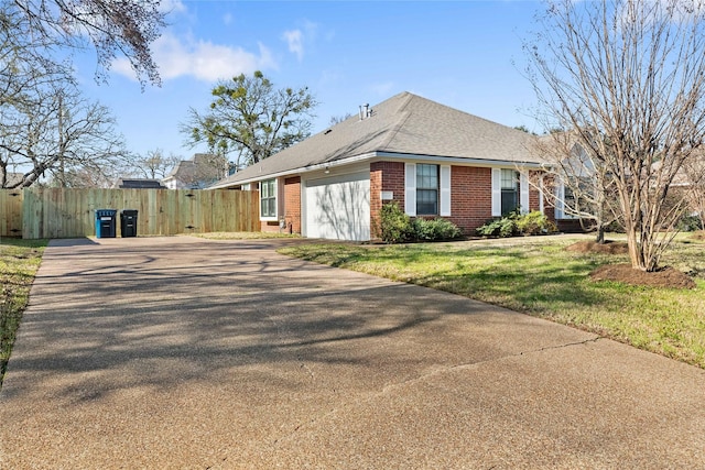 view of side of property featuring a garage and a lawn