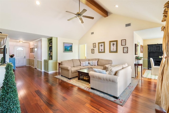 living room with dark hardwood / wood-style flooring, high vaulted ceiling, beam ceiling, and ceiling fan