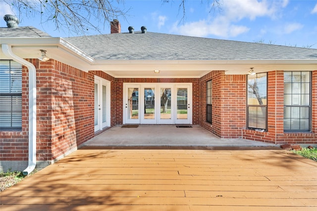 property entrance featuring a patio area and french doors