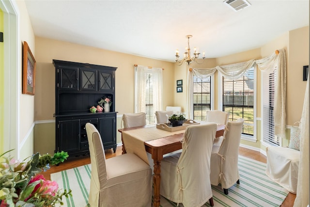 dining room with an inviting chandelier and wood-type flooring