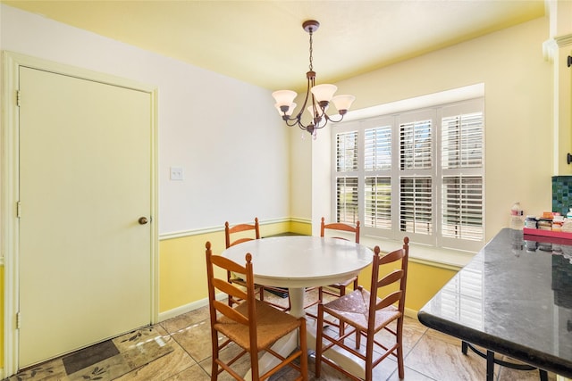 dining area with an inviting chandelier