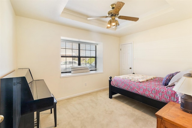 bedroom with ornamental molding, a raised ceiling, and light carpet