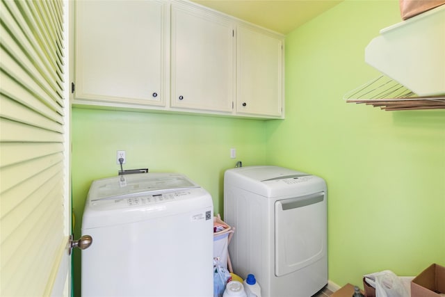 washroom featuring cabinets and washer and dryer