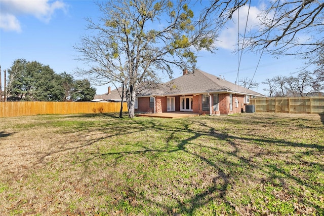 exterior space with cooling unit and a yard