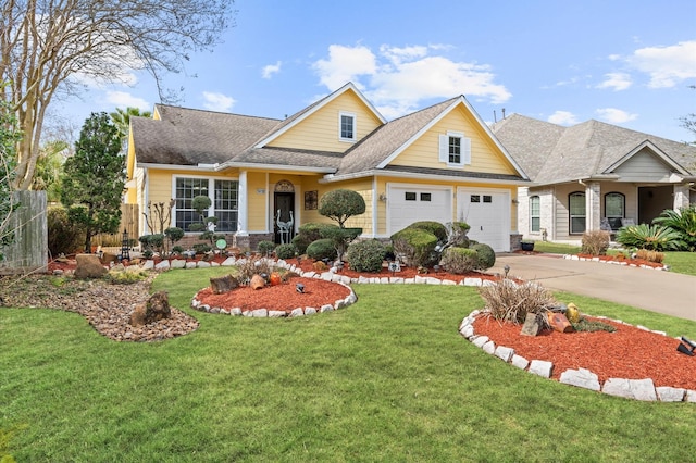 craftsman-style house with a shingled roof, a front yard, fence, a garage, and driveway