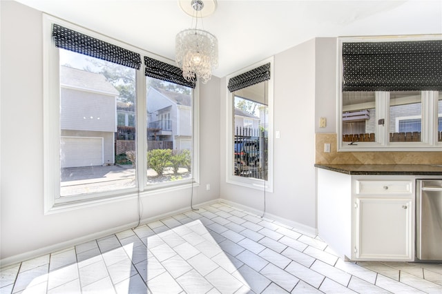 unfurnished dining area with a chandelier and light tile patterned floors