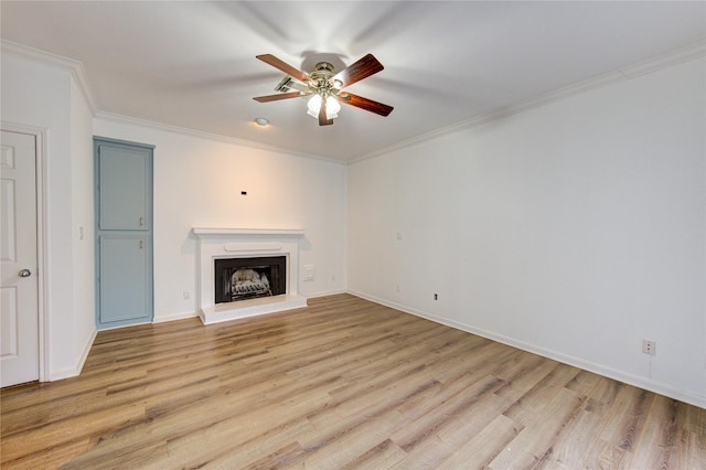 unfurnished living room with crown molding, ceiling fan, and light hardwood / wood-style flooring