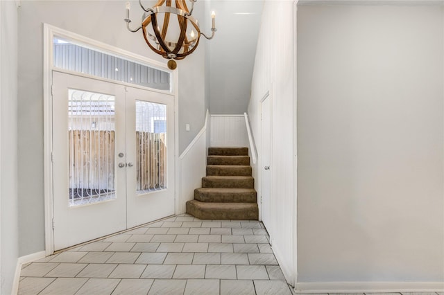 interior space with an inviting chandelier and french doors