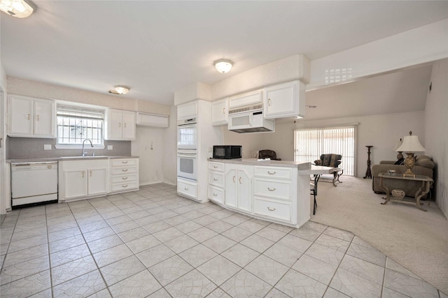 kitchen with white appliances and white cabinets