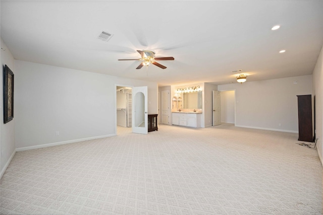 carpeted spare room featuring ceiling fan