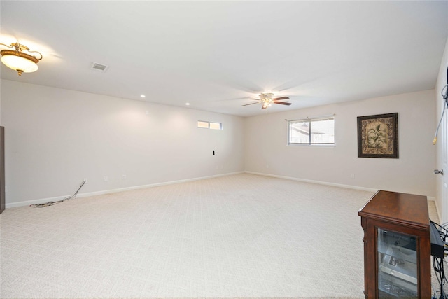 carpeted spare room featuring ceiling fan