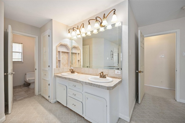 bathroom featuring toilet and vanity