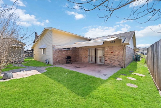 back of property featuring a yard and a patio