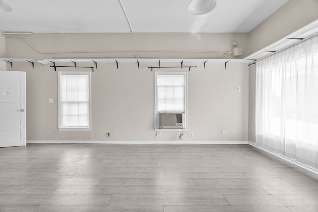 empty room with cooling unit and light wood-type flooring