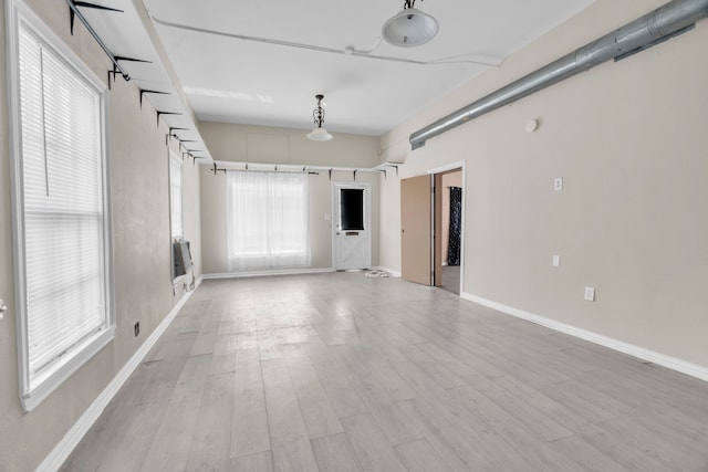 unfurnished room with light wood-type flooring