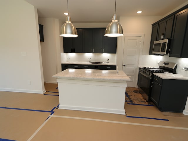 22435 Birchfield Grove Ln, New Caney, TX 77357 - kitchen with stainless steel microwave, black range with gas stovetop, decorative backsplash, a center island, and light stone counters