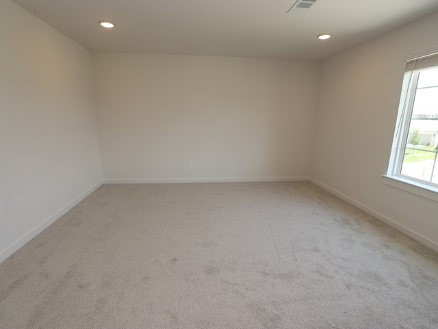 22435 Birchfield Grove Ln, New Caney, TX 77357 - spare room featuring light carpet, healthy amount of natural light, baseboards, and recessed lighting
