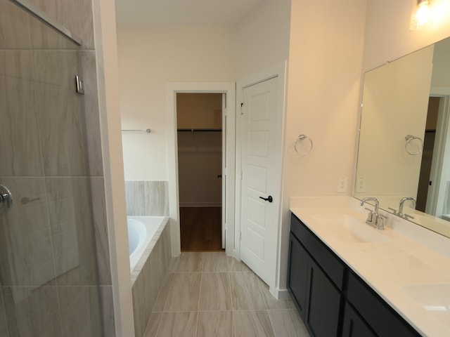 22435 Birchfield Grove Ln, New Caney, TX 77357 - bathroom featuring double vanity, a garden tub, tiled shower, and tile patterned flooring