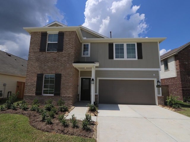 22435 Birchfield Grove Ln, New Caney, TX 77357 - view of front facade featuring board and batten siding, an attached garage, driveway, and brick siding
