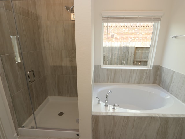 22435 Birchfield Grove Ln, New Caney, TX 77357 - full bath with a shower stall, a garden tub, and healthy amount of natural light