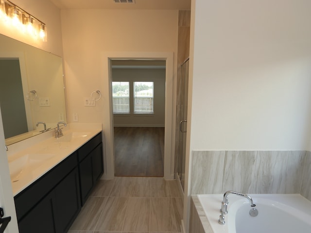 22435 Birchfield Grove Ln, New Caney, TX 77357 - bathroom with double vanity, a bath, tile patterned floors, and a shower stall