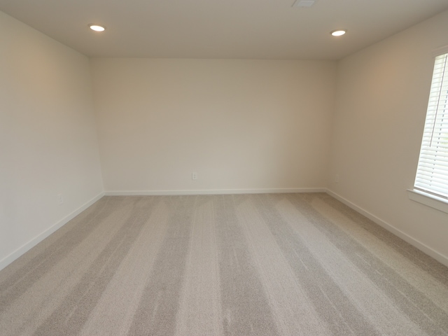 22435 Birchfield Grove Ln, New Caney, TX 77357 - empty room with light carpet, recessed lighting, and healthy amount of natural light