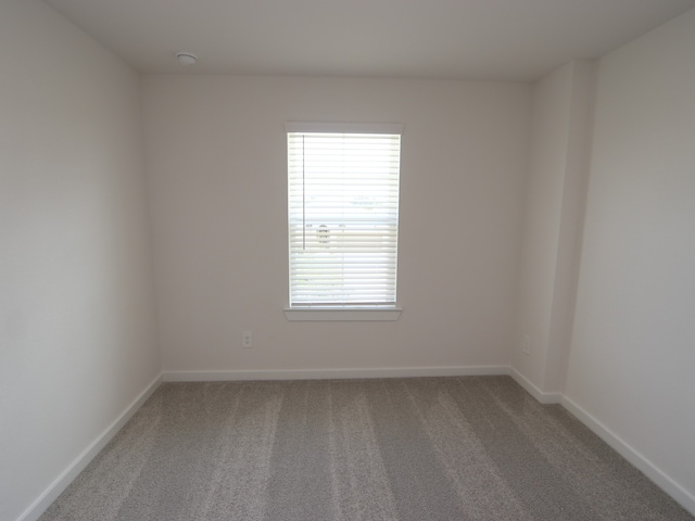 22435 Birchfield Grove Ln, New Caney, TX 77357 - spare room with carpet and a smoke detector