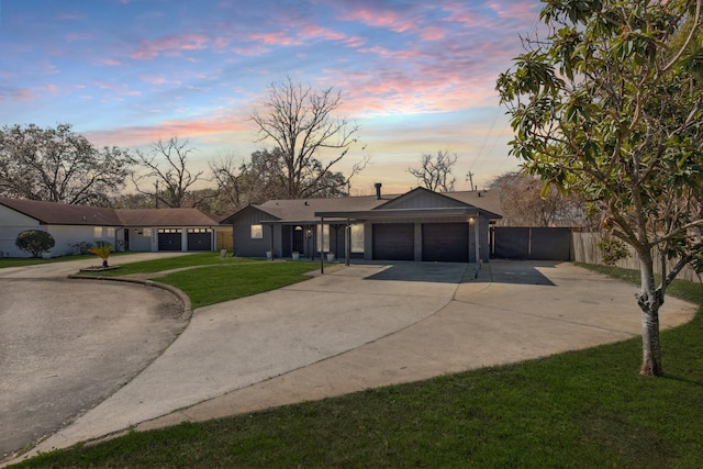 ranch-style house with a yard and a garage