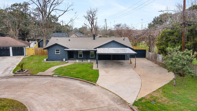 ranch-style house featuring a front yard, a garage, and a carport