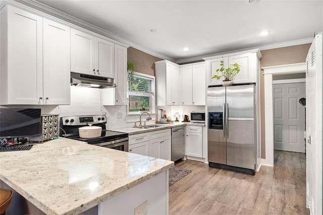 kitchen with sink, appliances with stainless steel finishes, white cabinets, and light stone counters