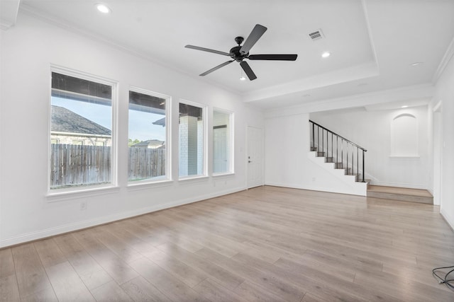 unfurnished living room with a mountain view, visible vents, light wood-style floors, stairs, and ornamental molding