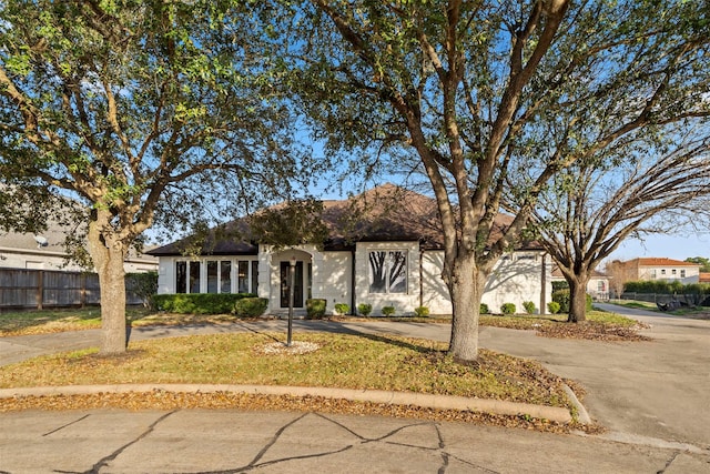 view of front of property with driveway and fence