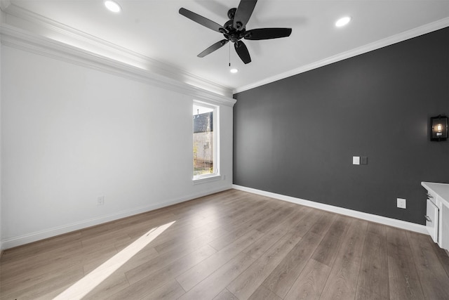 spare room with light wood-style flooring, ornamental molding, baseboards, and recessed lighting