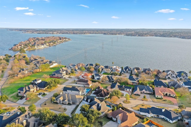 drone / aerial view featuring a water view and a residential view