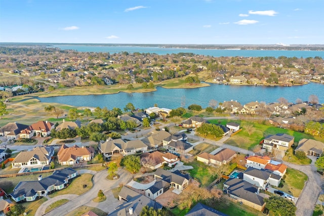 drone / aerial view featuring a residential view and a water view