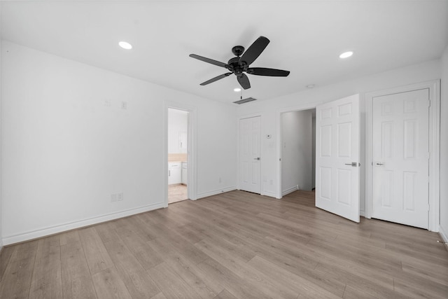 unfurnished bedroom with visible vents, baseboards, light wood-style flooring, ensuite bathroom, and recessed lighting