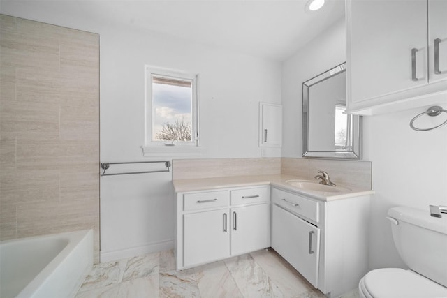 bathroom with toilet, marble finish floor, and vanity