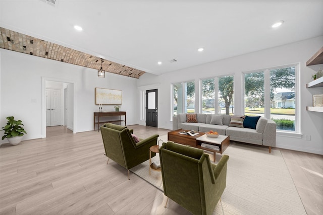 living area with lofted ceiling, light wood finished floors, recessed lighting, and baseboards