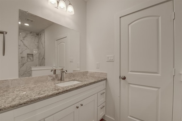 bathroom featuring vanity and tiled shower