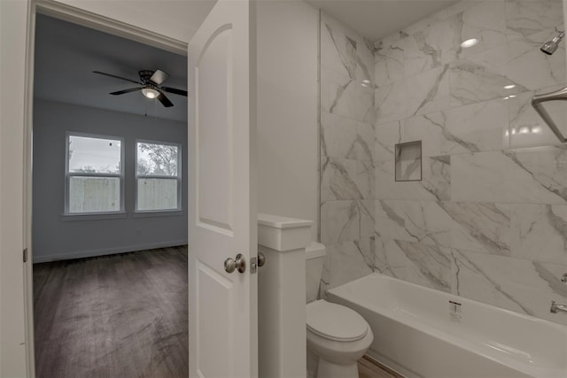 bathroom with toilet, tiled shower / bath combo, wood-type flooring, and ceiling fan