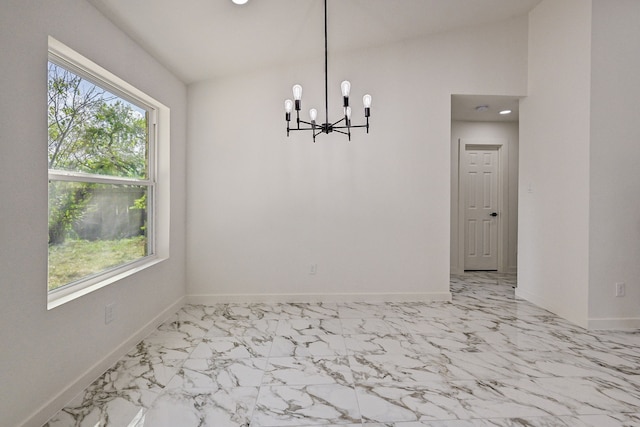 unfurnished dining area with a chandelier and vaulted ceiling