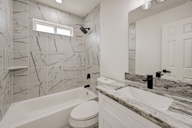 full bathroom with toilet, vanity, and tiled shower / bath