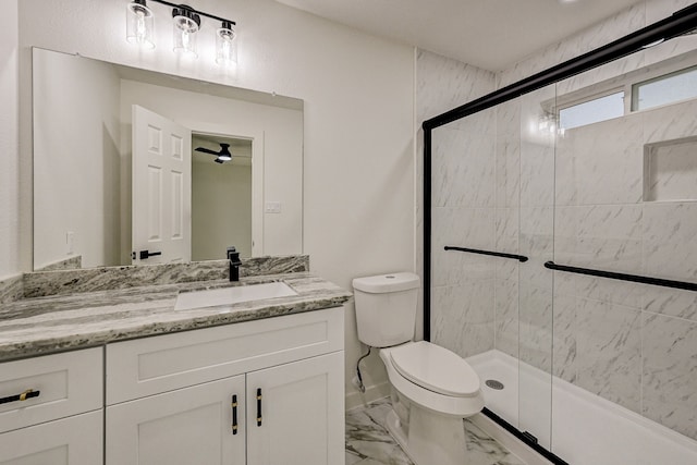 bathroom with toilet, vanity, and a shower with door