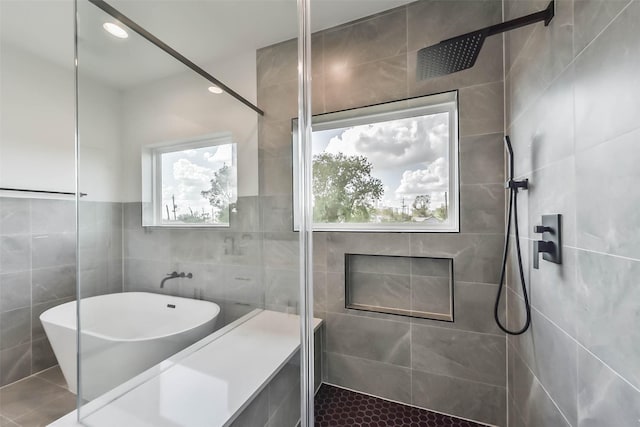 4430 Edmund St, Houston, TX 77020 - full bath featuring tile walls, a tile shower, a freestanding tub, tile patterned flooring, and recessed lighting