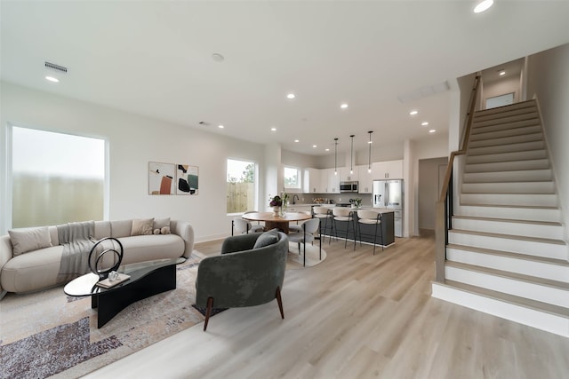 4430 Edmund St, Houston, TX 77020 - living area with stairway, light wood-style flooring, and recessed lighting