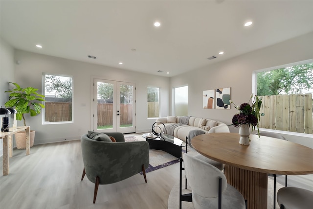 living area with recessed lighting, french doors, light wood finished floors, and visible vents