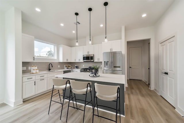 4430 Edmund St, Houston, TX 77020 - kitchen with stainless steel appliances, a sink, tasteful backsplash, light countertops, and white cabinetry